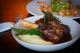 Slow cooked lamb shank on creamy mash with char-grilled broccolini and asparagus